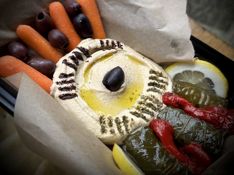 The Evil Eye: hummus with a kalamata olive center, dolmas, peppers and olives