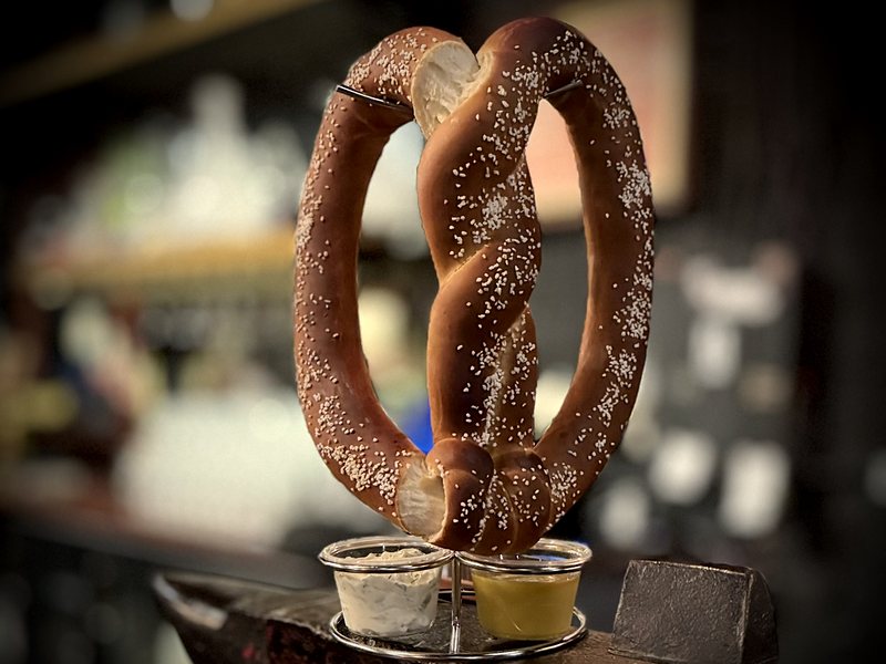 The Giant&rsquo;s Pretzel standing on an anvil with two dips